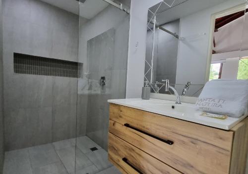 a bathroom with a sink and a shower at HOTEL SANTAFE NATURA - SANTAFE DE ANTIQUIA in Santa Fe de Antioquia