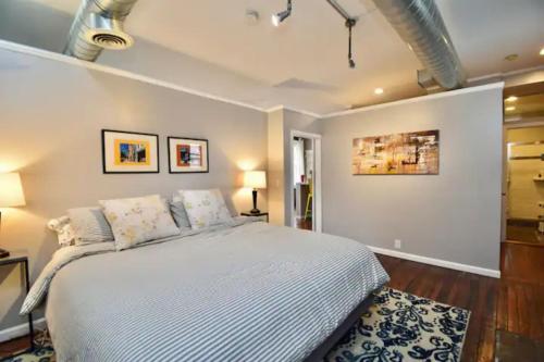 a bedroom with a large white bed in a room at Walk to Everything - Sports, Food, Music, Downtown in Cincinnati