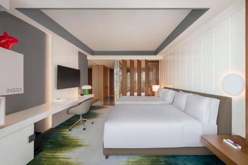 a hotel room with a bed and a desk at W Taipei in Taipei