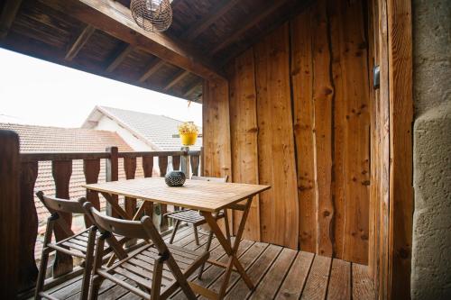 - une terrasse couverte en bois avec une table et des chaises dans l'établissement Charmant T2 indépendant entre Vercors et Chambaran, à Chatte