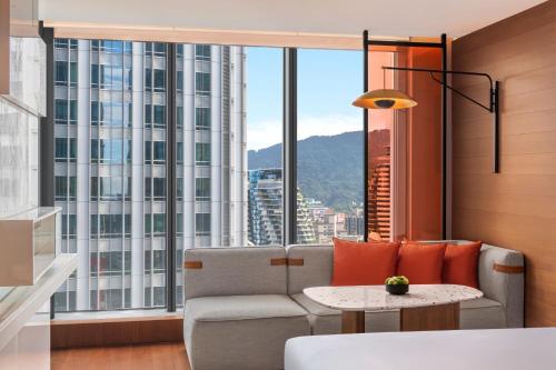 a living room with a couch and a table at W Taipei in Taipei