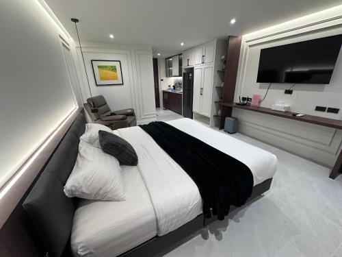 a hotel room with a large bed and a television at Chill Chill at Nimman in Chiang Mai