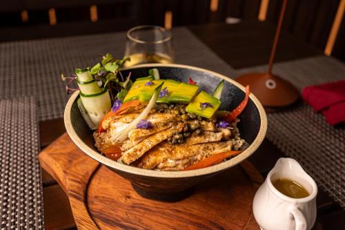 a bowl of food sitting on a wooden table at Seiri del Mar in Hopkins