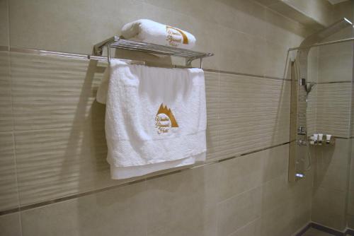 a towel hanging on a towel rack in a bathroom at Pyramids Wonders Hotel in Cairo
