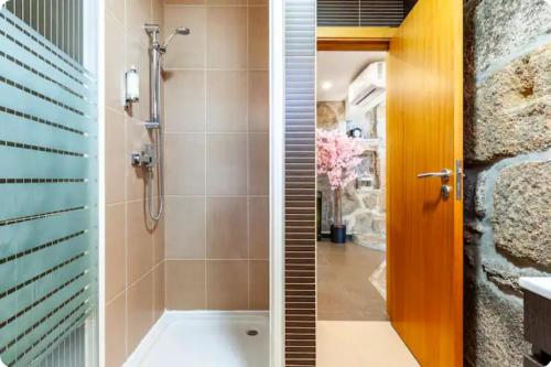 a bathroom with a shower and a sink at Casa da Fonte Gerês in Campo do Gerês