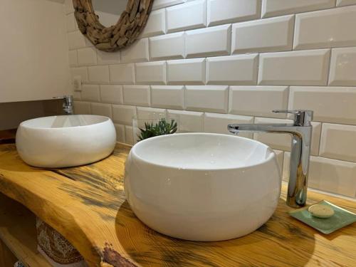 a white bowl sink on a wooden counter in a bathroom at Le Refuge du 55 in Epfig
