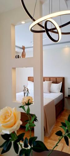 a bedroom with a bed and a flower at Jacuzzi Life in Subotica