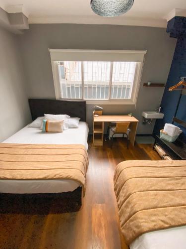 Cama o camas de una habitación en TQCaleta Providencia Barrio Italia