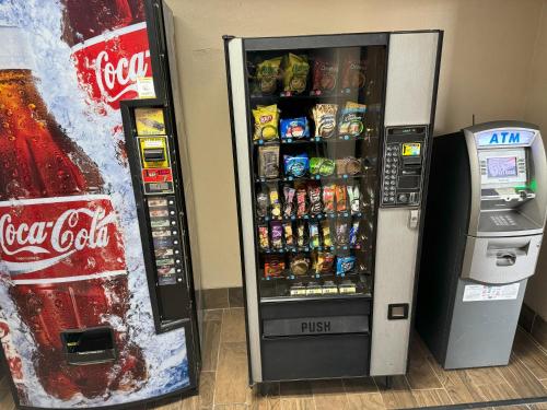a coca cola vending machine next to a soda machine at Super 8 by Wyndham Winfield-Quail Ridge Area in Winfield