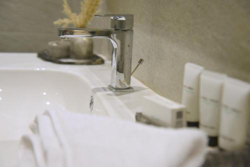 a bathroom sink with a faucet on top of it at Pyramids Wonders Hotel in Cairo