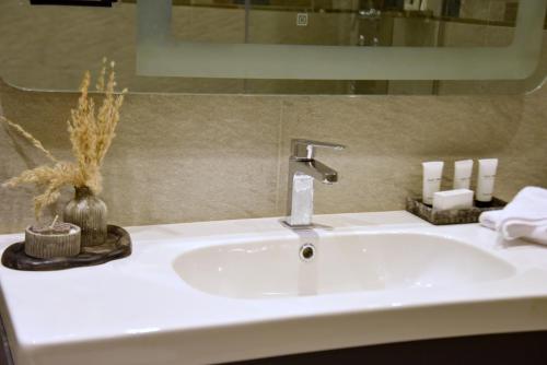 a white sink in a bathroom with a mirror at Pyramids Wonders Hotel in Cairo