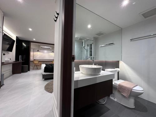 a bathroom with a sink and a toilet at Chill Chill at Nimman in Chiang Mai