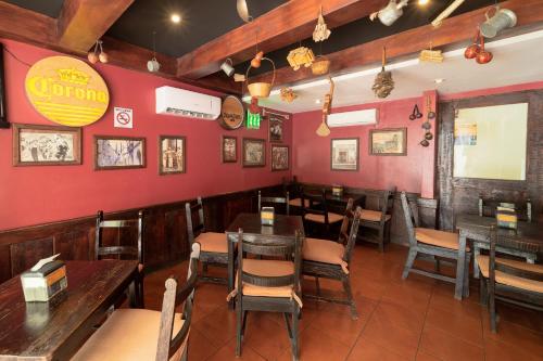 a restaurant with wooden tables and chairs and red walls at Comfort Inn Real San Miguel in San Miguel