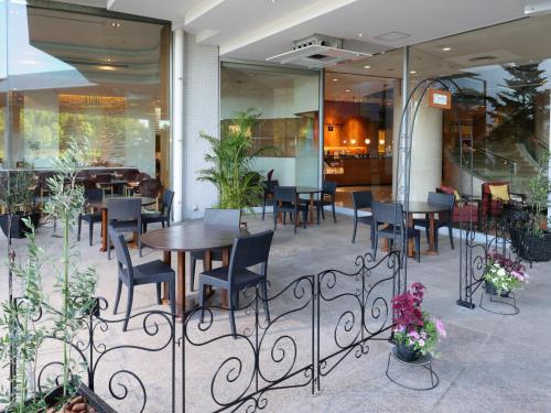 a restaurant with a wooden table and chairs in front of a building at ANA Crowne Plaza Narita by IHG in Narita