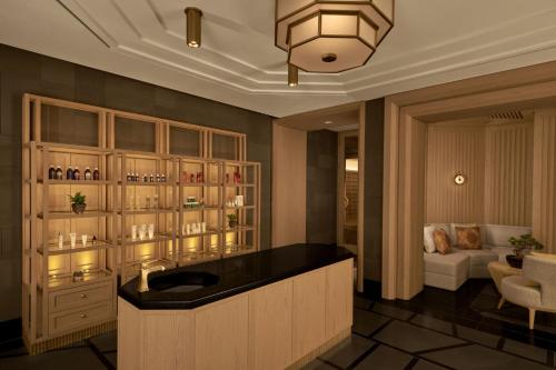 a bathroom with a sink and a room with a couch at JW Marriott Jeju Resort & Spa in Seogwipo
