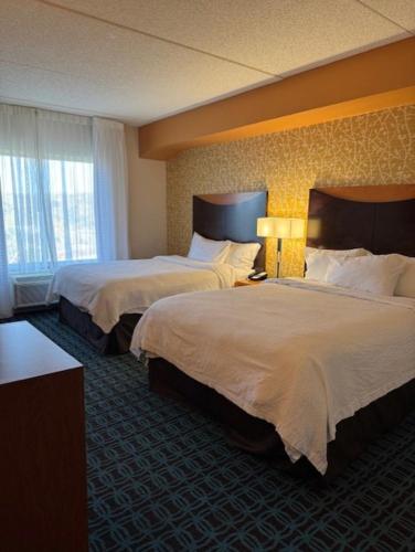 a hotel room with two beds and a window at Fairfield Inn by Marriott Morgantown in Morgantown