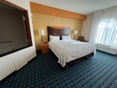 a hotel room with a bed and a flat screen tv at Fairfield Inn by Marriott Morgantown in Morgantown