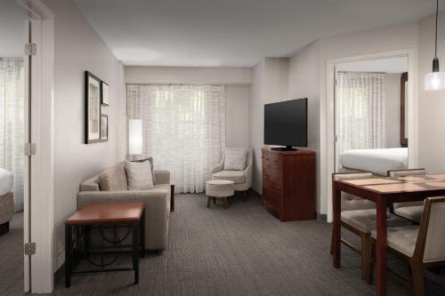 a hotel room with a bed and a television at Residence Inn by Marriott Greensboro Airport in Greensboro
