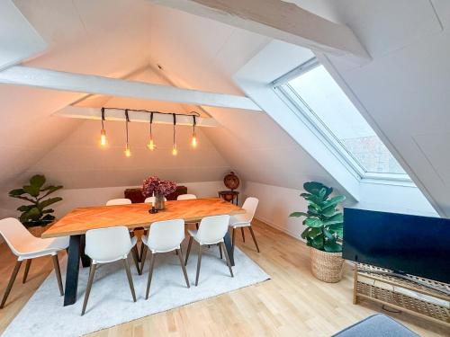 a dining room with a wooden table and chairs at Spacious and modern house close to Århus Center in Aarhus
