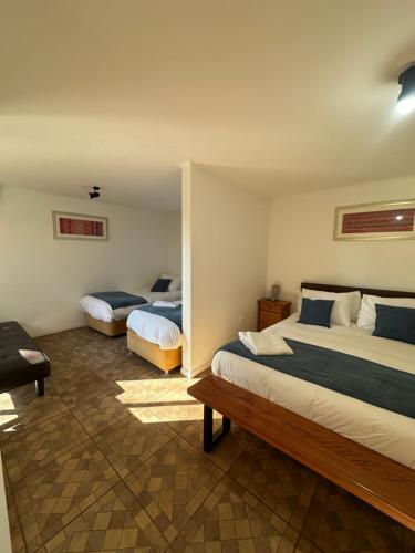 a hotel room with two beds in a room at San Francisco Lodge in Los Andes