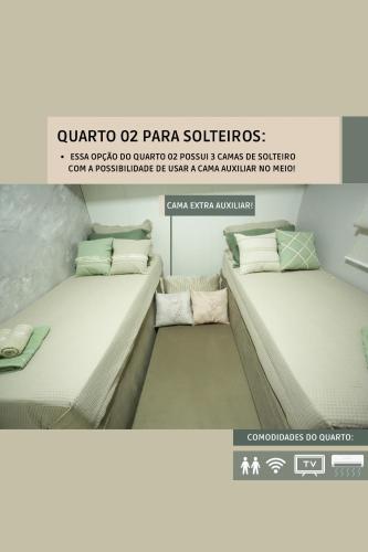 two beds in a room next to each other at O melhor Apê da Região com Ar Cond, Wi-Fi e Hidromassagem in Brasilia