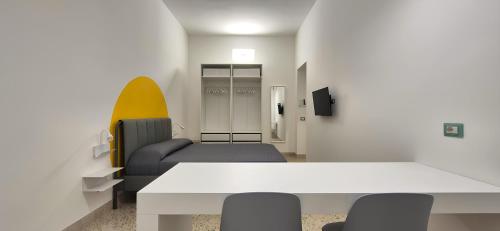 a room with a couch and a table and chairs at Casa Sunrise - The Guest House in Sciacca