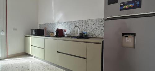a kitchen with a counter with a coffee maker on it at Casa Sunrise - The Guest House in Sciacca