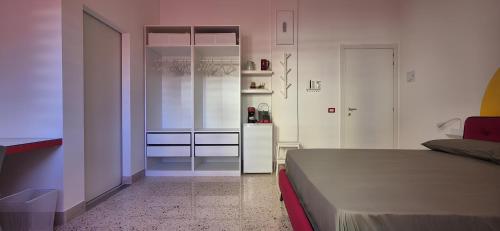 a bedroom with a bed and a small kitchen at Casa Sunrise - The Guest House in Sciacca