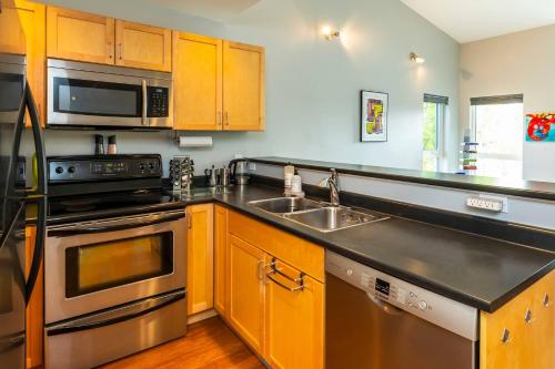 a kitchen with a sink and a stove top oven at NN - The Kit 4 - Downtown 1-Bed 1-Bath in Whitehorse