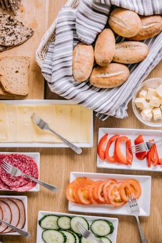 a table topped with plates of bread and vegetables at Hlid Bed and Breakfast in Myvatn