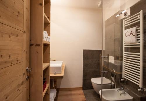 a bathroom with a toilet and a sink at Chalet Alfonz in Bormio