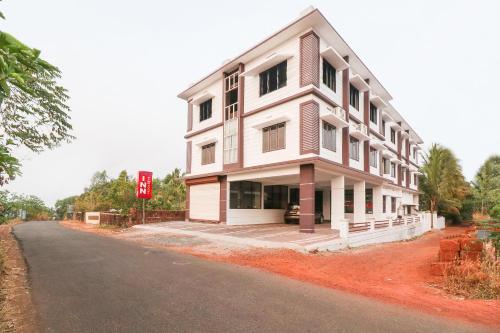 a large white building on the side of a road at SPOT ON Rohini Inn Kadampuzha in Malappuram