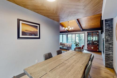 a dining room with a wooden table and chairs at Spruce Creekside in Vail