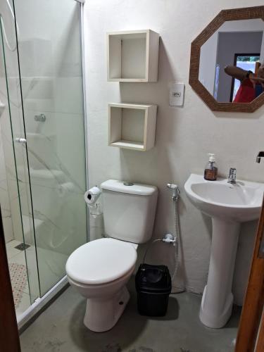 a bathroom with a toilet and a sink and a shower at Casa Natureza in Camaçari