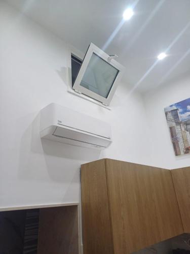 a tv on a white wall in a room at B&B Romeo2 in Bari