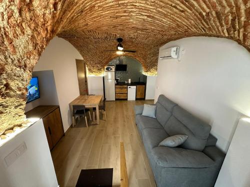 a living room with a couch and a table at Entre Bóvedas in Cáceres