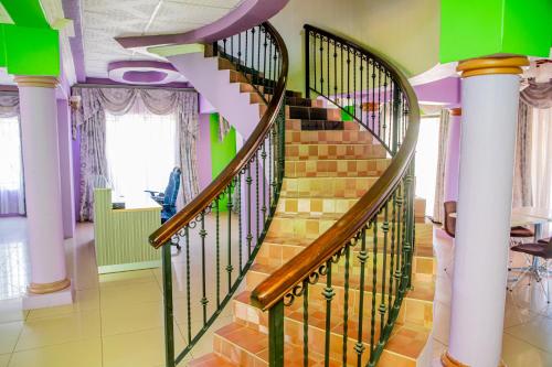 a spiral staircase in a home with green and purple at The Albatross in Gaborone