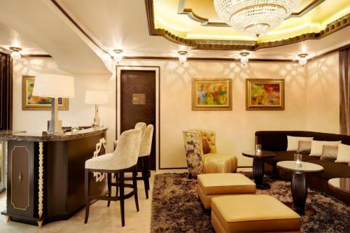 a living room with a couch and a table and chairs at The St. Regis Abu Dhabi in Abu Dhabi