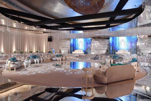 a ballroom with a large lobby with tables and chairs at The St. Regis Abu Dhabi in Abu Dhabi