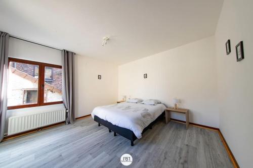 a bedroom with a bed and a large window at appartement 1ch mons centre in Mons
