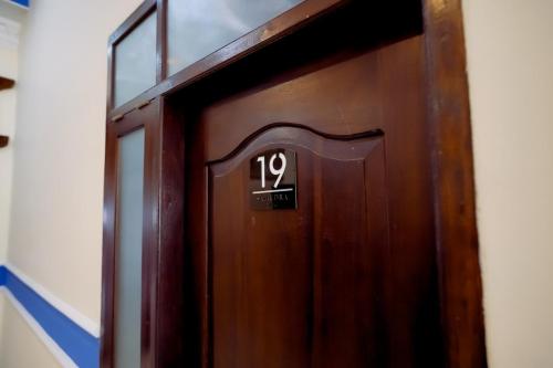 a wooden door with the number on it at Samudra Hotel in Jepara