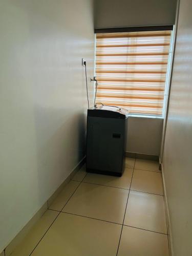 a small room with a window and a tiled floor at Focuz Habitat Hotel And Ayurveda in Malappuram