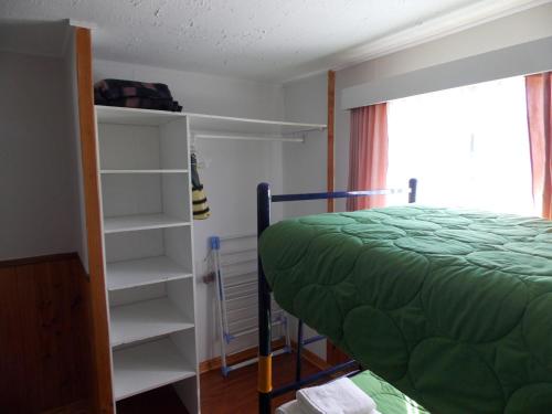 a bedroom with a bed and a book shelf at Cabañas Inadeqin in Ensenada