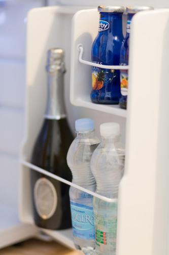 a refrigerator filled with bottles of water and drinks at ControVento Rooms in Margherita di Savoia