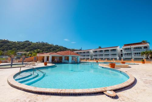 a large swimming pool in front of a building at Golden Villas 306 studio in Isabela