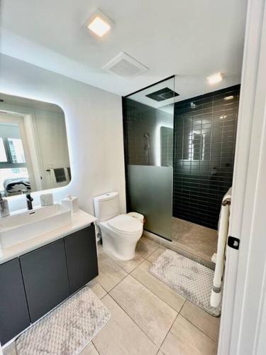 a bathroom with a toilet and a sink and a shower at Spacious Studio in the Heart of Downtown Miami in Miami