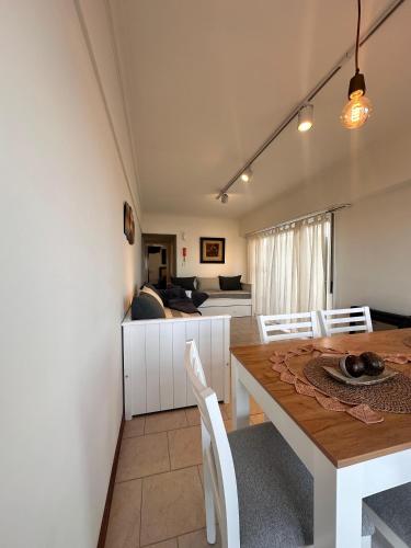 a dining room and living room with a table and chairs at Amanecer frente al mar 2 in Mar del Plata