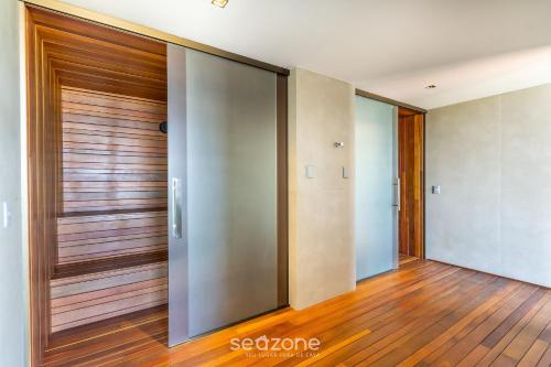 an elevator lobby with wooden doors and wooden floors at NWTs - Apartamentos com Vista Frente-Mar em Maceió in Maceió