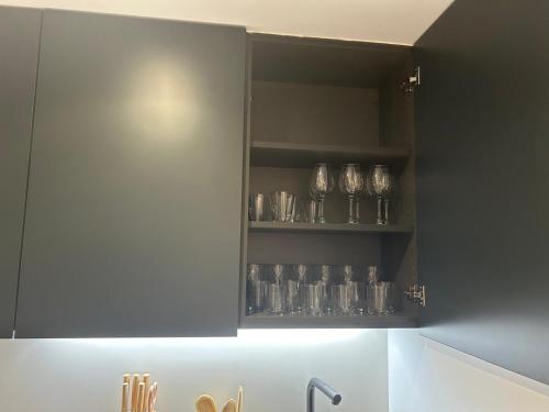 a cupboard filled with glasses sitting on a shelf at Loft Atemporal, centro de Ciudad Real in Ciudad Real