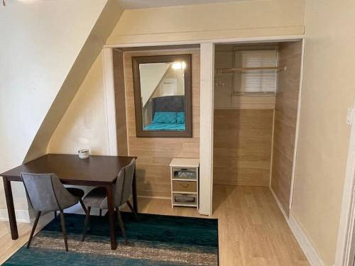 a dining room with a table and a mirror at Exquisite Rogers Park 1 bedroom, 1 bath Apartment Near Evanston in Chicago